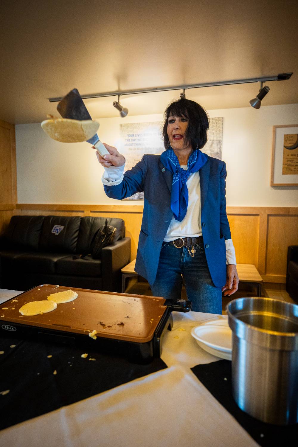 President Mantella flipping a pancake onto griddle.